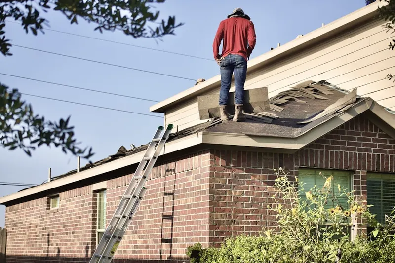 Professional roofer working on a residential roof in Bellaire